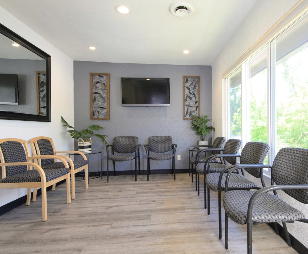 {PRACTICE_NAME} waiting room with chairs lining the walls